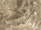 a glass vase with a flower inside of it