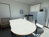 a white table with blue legs in a room