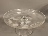 a glass cake plate on a stand on a table