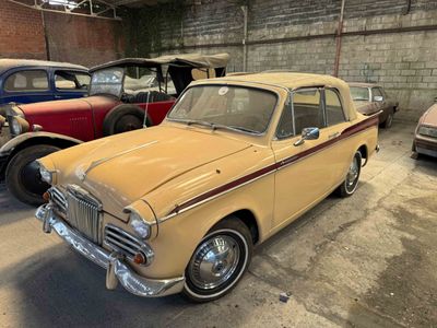 many old cars parked in a garage next to each other