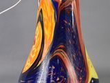 an image of a colorful lamp with a metal base and a cord