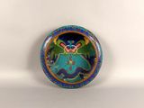 a picture of a blue and green plate with a butterfly on it
