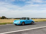a blue car that is driving down the road