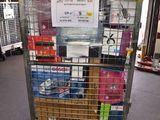 a metal cart with many items in it in a warehouse