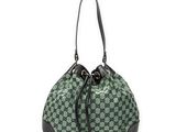 un sac à main vert et noir avec des anses noires sur fond blanc