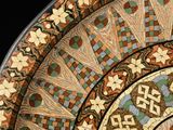 a close up of a decorative plate on a black background