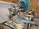 a machine that is cutting a piece of wood with a circular blade