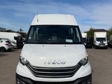 the white van is parked in a parking lot with other vehicles