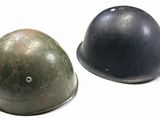 two helmets sitting next to each other on a white surface