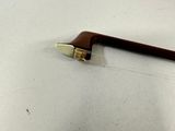 a small piece of wood on the floor next to a pair of scissors