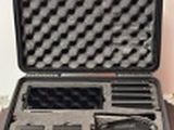 a black case with a gun inside of it on a table