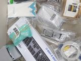 a lot of electronic items that are on the couch