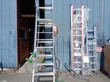 two ladders that are sitting in front of a building