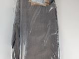 men ' s grey pants in a bag on a white surface