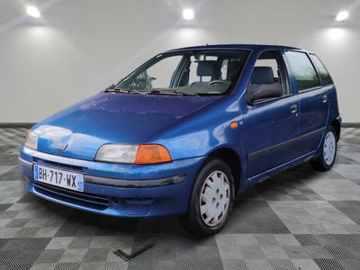 a picture of a blue car parked in a garage