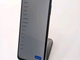 a phone that is sitting on a stand on a table