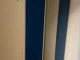 three blue and white stalls in the corner of a room