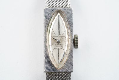 une montre posée sur une surface blanche
