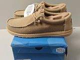 men ' s sued moccali shoes on top of a blue box