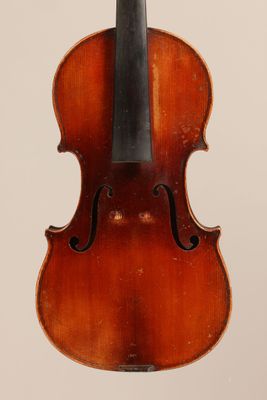 an old violin with a bow hanging from it ' s back