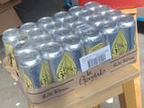 many cans of soda sitting on a wooden table