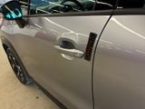 a car door handle with a sticker on it