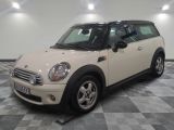 a picture of a white mini cooper parked on a checkered floor