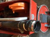 a red box with a metal pipe and a black pipe