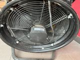 a black fan sitting on top of a metal stand