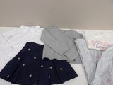 a lot of clothes that are sitting on a table
