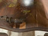 a wooden table with a metal handle on it