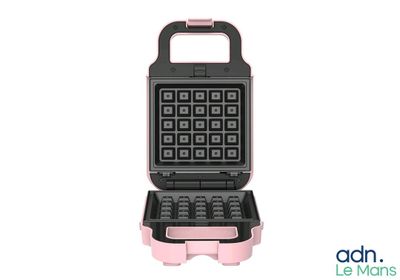 a close up of a waffle maker on a white background