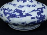 a blue and white vase with a dragon design on it