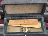 a small wooden ruler in a case on a table