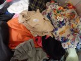 a pile of clothes that is sitting in a box