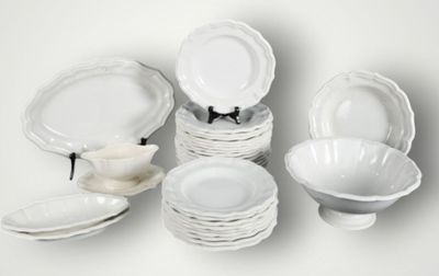 a lot of white plates and bowls on the table