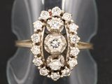 a close up of a diamond ring on a clear surface