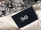 a close up of a white shirt with black lace on it