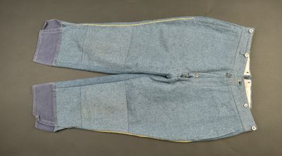 pair of blue jeans with yellow zippers laying on a table