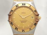 a gold and silver watch with roman numerals on it