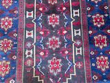 an oriental rug with a blue and red design on it
