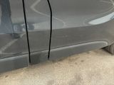 a close up of a car ' s door handle with a sticker on it