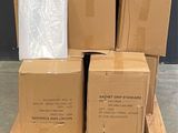 boxes stacked on a pallet in front of a black wall