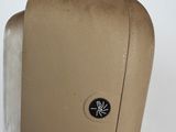 a tan hand dryer sitting on a white surface