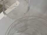 a glass bowl with a liquid inside of it on a table