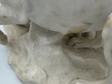 a statue of a cow that is sitting on a table