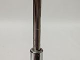 a close up of a metal pipe on a white surface