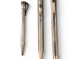 three different types of pens sitting next to each other on a white surface