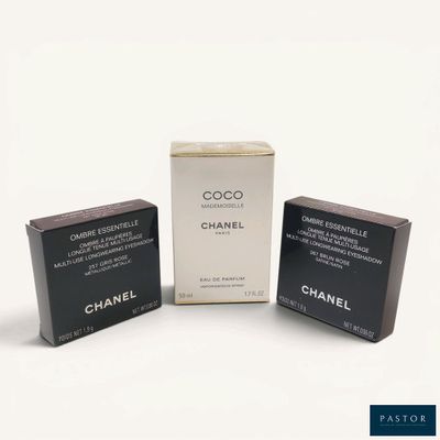 three boxes of chanel perfume on a white surface