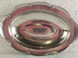 a silver plate with a pink design on it